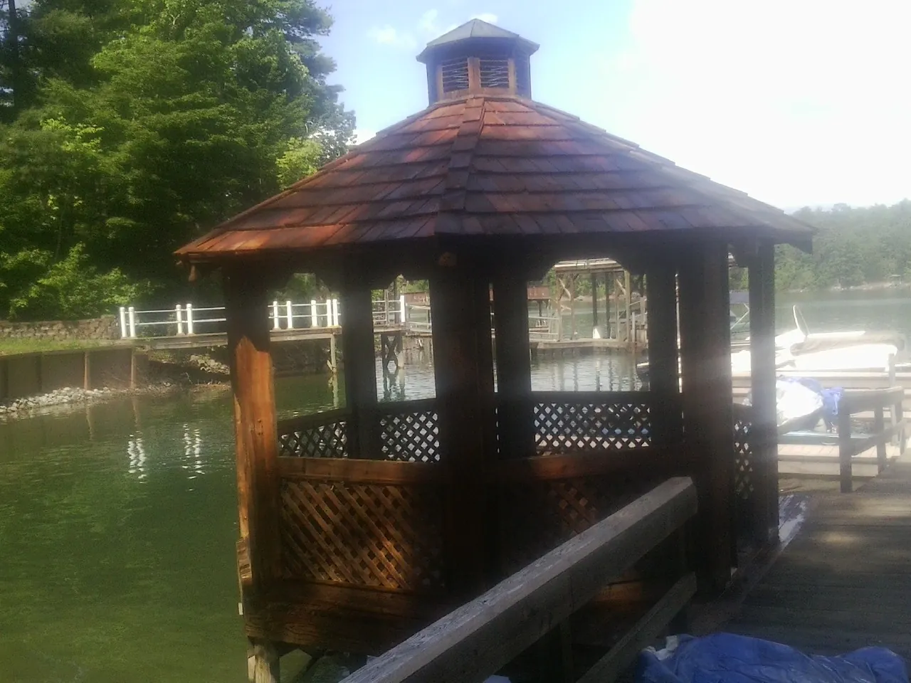 Cedar shake gazebo roof rebuilt on a lake dock in Otis Orchards